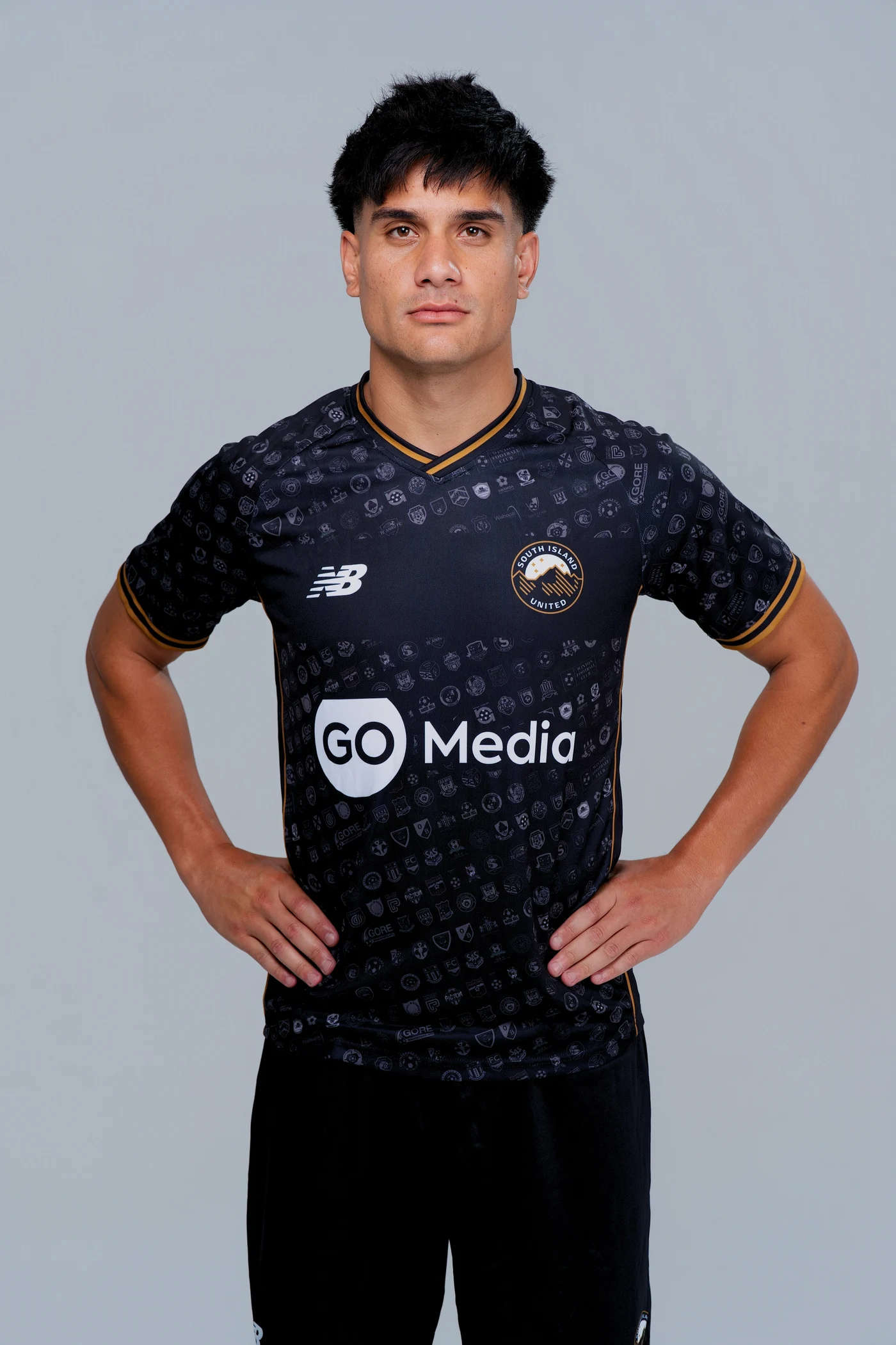 South Island United player wearing the black and gold away kit